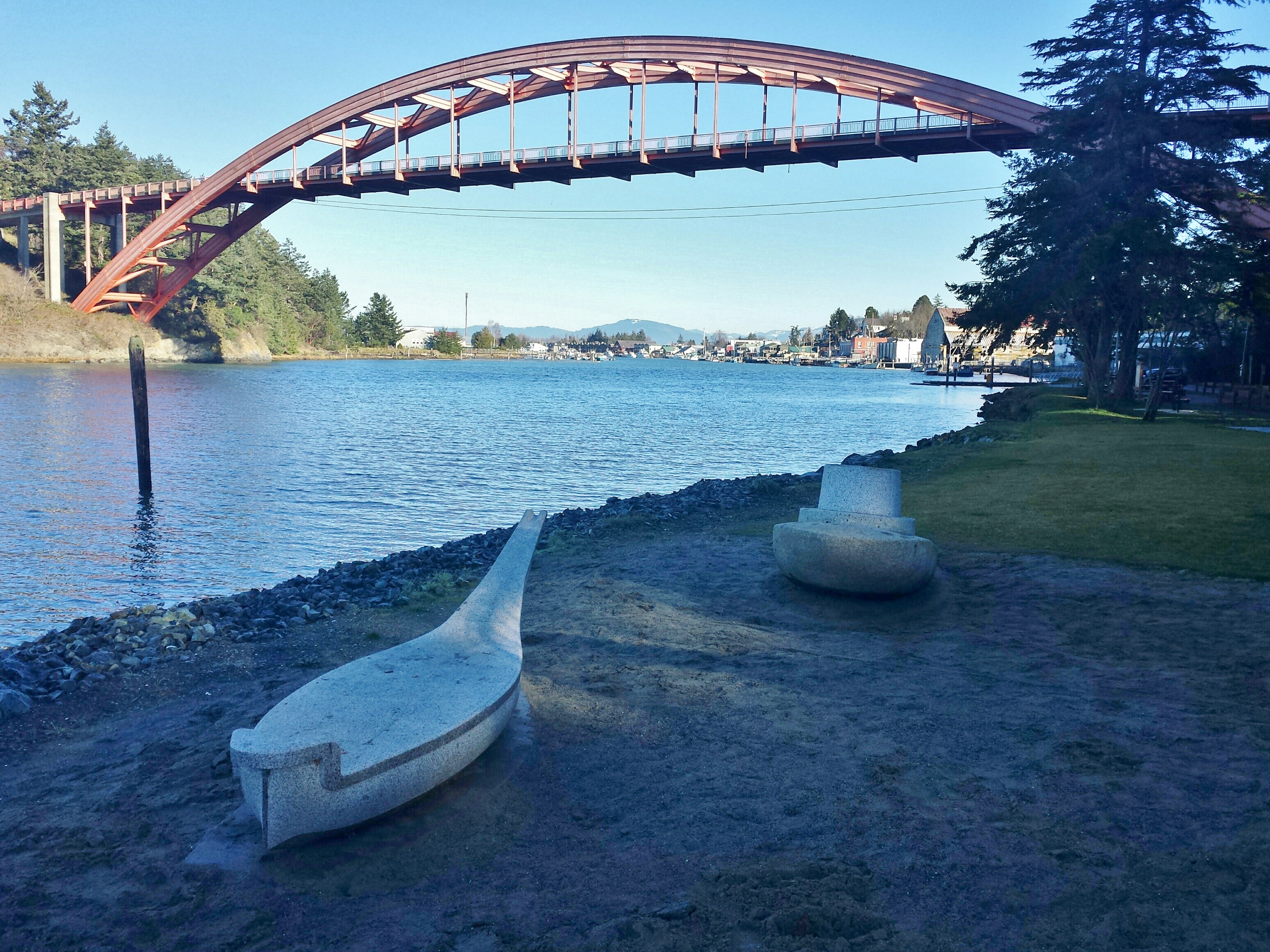 The tugboat and the canoe resting easy, framed by the Rainbow Bridge, another crossing point between two cultures.