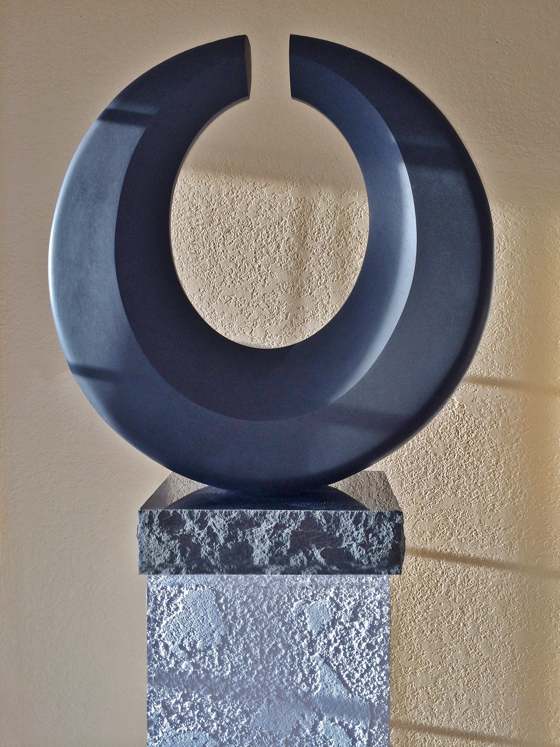 Another “Threshold” piece, basalt, 22"H x 21"W x 4"D at the base, tapering to 2 1/2"D at the top.