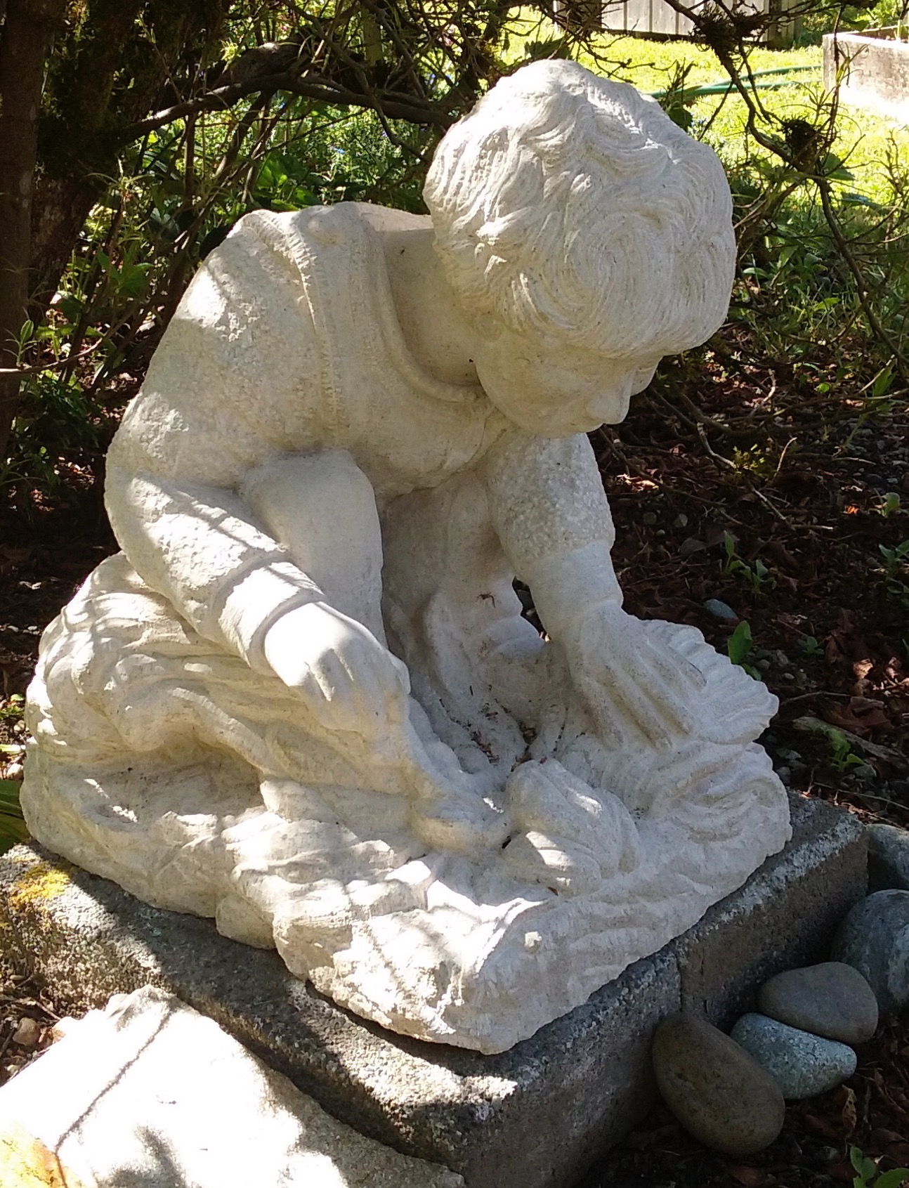 . “Child’s World”, limestone, 2016, 14” X 20” X 18’      The child has found a frog.