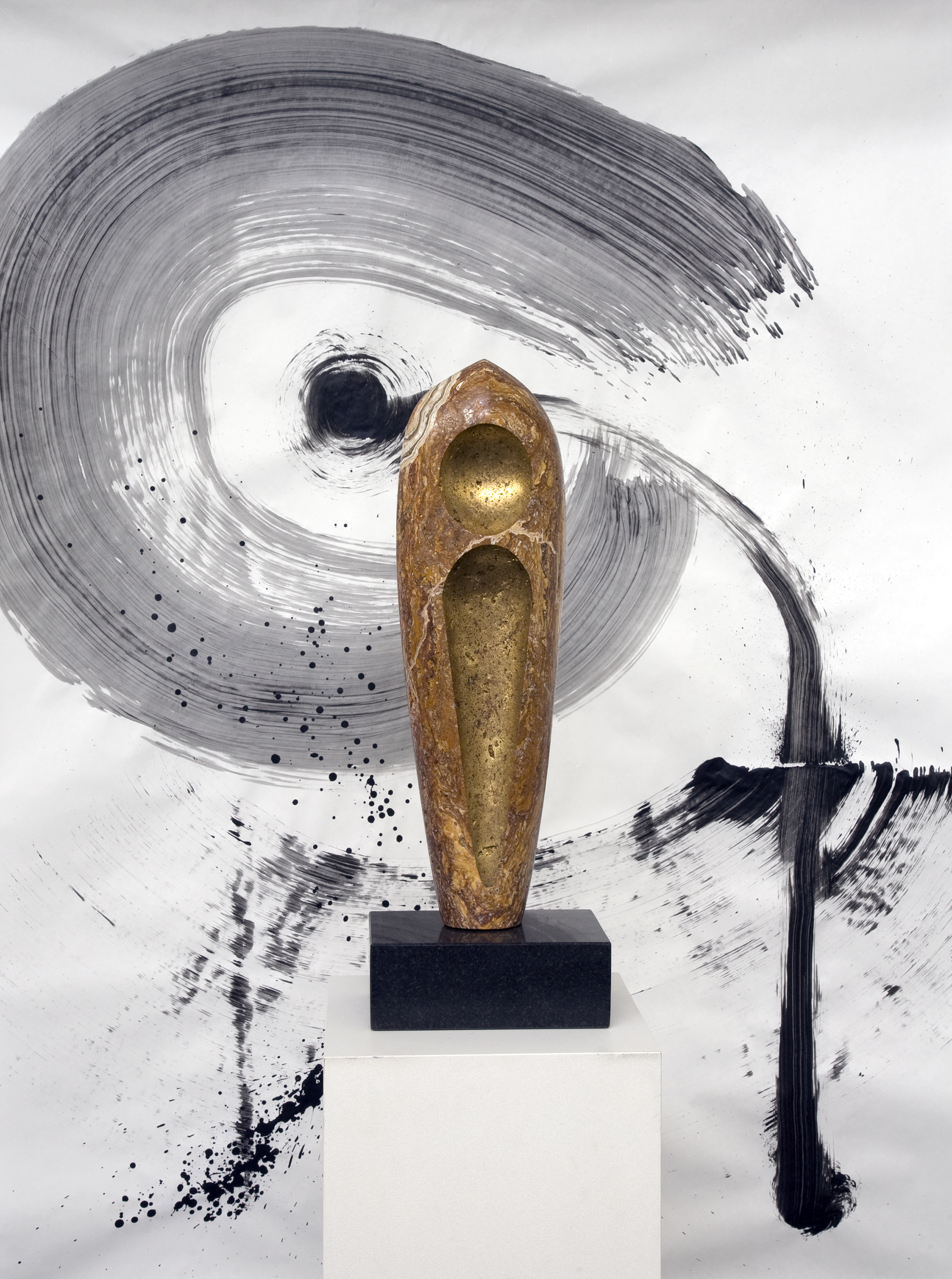 “Chrysalis”, travertine with onyx inclusions, 15” X 7” X 4.” The sumi-e painting behind the sculpture is by Jim Ballard. Note how the lines in the top of this sculpture seem to merge with the sumi-e painting in the background.