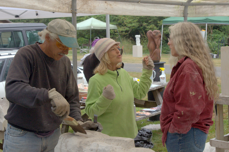 Kimberly Oliver making a point to our AAC instructor Carole Murphy while Mark Andrew works on his cement kissers. 